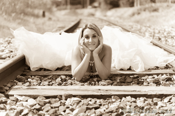 Photographie d'une mariée allongée sur une voie de chemin de fer réalisée par Huitièm'art, photographe à Avignon (Vaucluse)